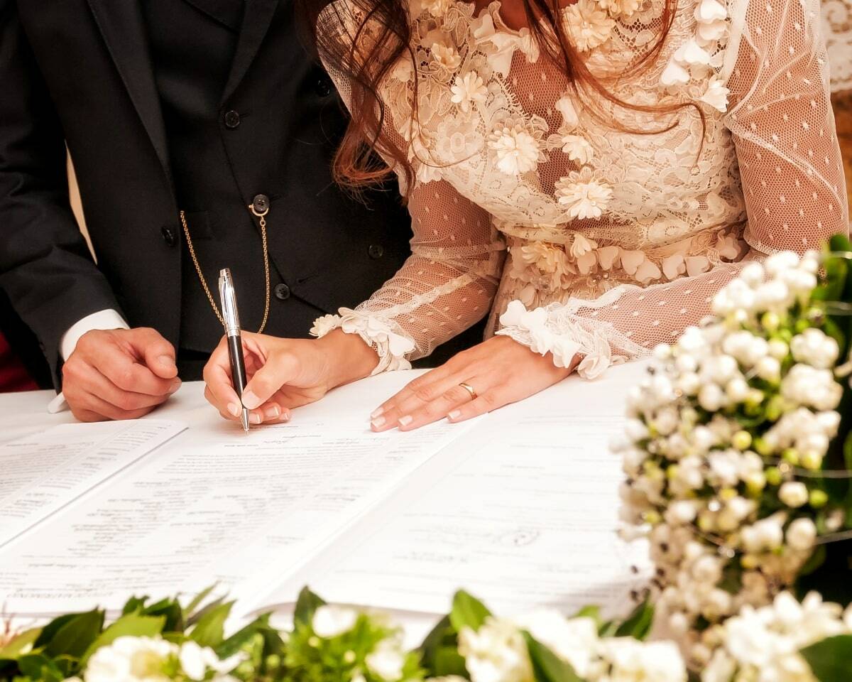 Hands signing during the wedding.