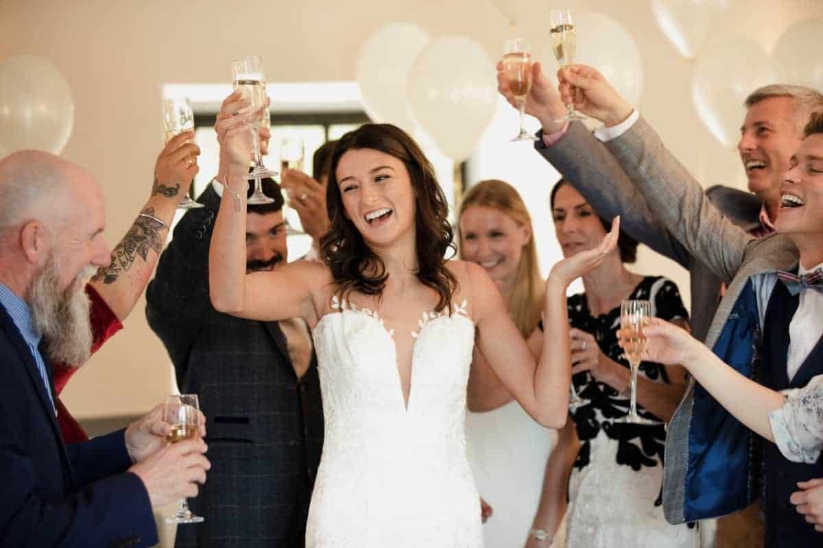 Wedding Bride cheers with guests.