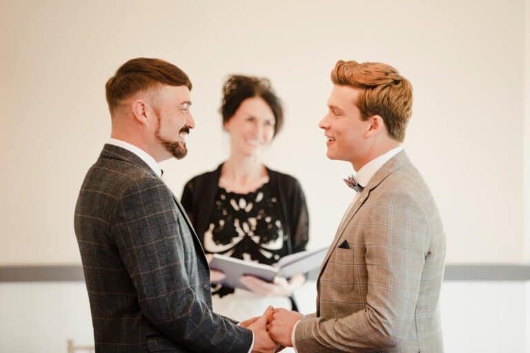 Two men are exchanging vows on their wedding day.