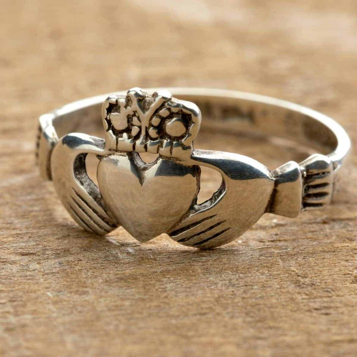 claddagh ring on wooden board.