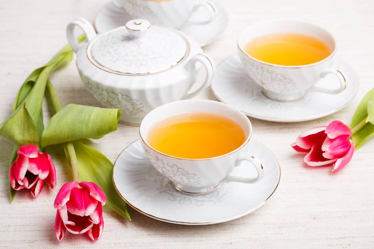 White tea set with flowers surrounding