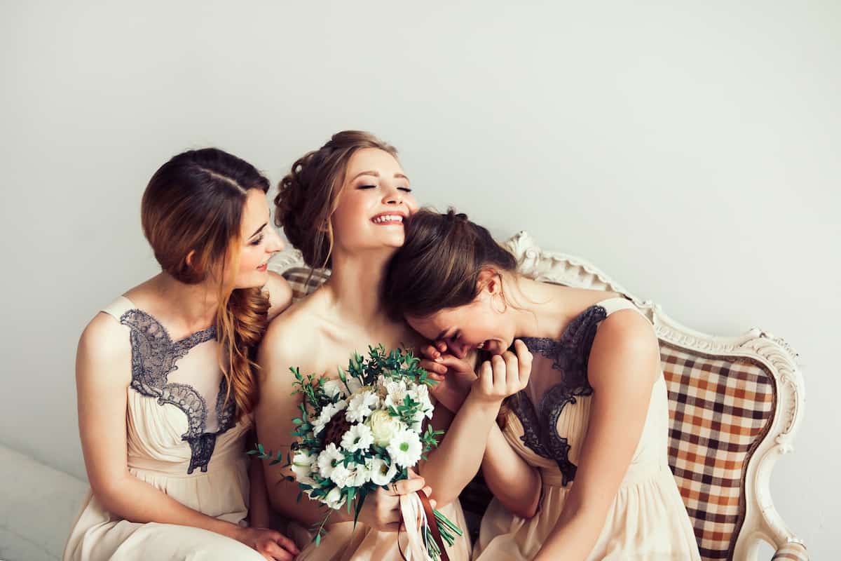 cheerful bride with her girlfriends sitting together . photo with copy space